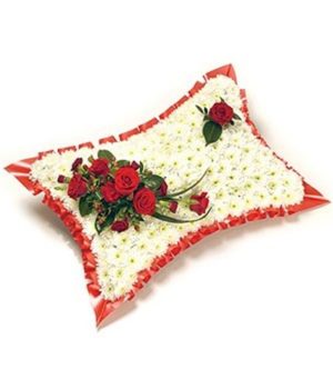 Red and white pillow. based pillow with white chysanths and red rose top spray with ribbon edge £80