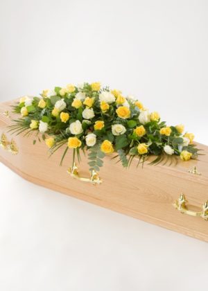 yellow and white rose casket spray